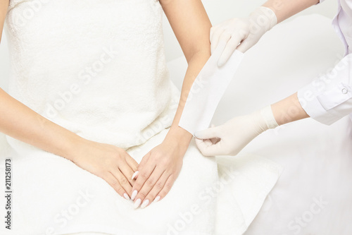 Sugar hair removal from woman body. Wax epilation spa procedure. Procedure beautician female. Forearm