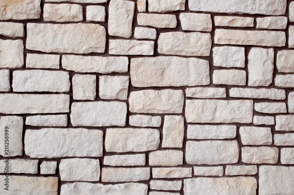 wall made of stone of different shape beige wall made of stone of different shape beige
