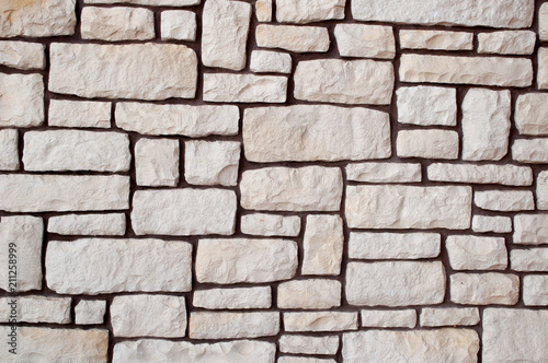 wall made of stone of different shape beige