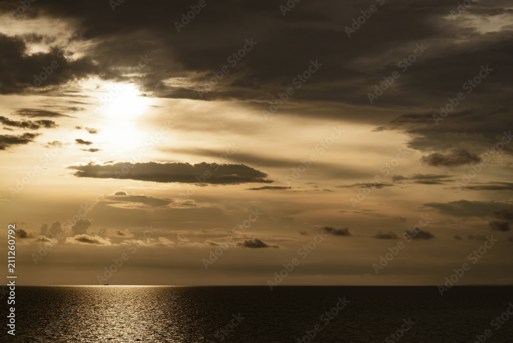 golden dark sunset and clouds over the sea golden dark sunset and clouds over the sea
