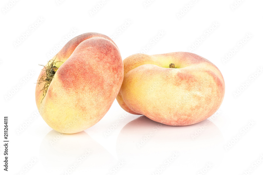 Two fresh Saturn peaches isolated on white background ripe fruit. Two fresh Saturn peaches isolated on white background ripe fruit.