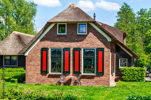 Traditional house with rustic thatched roof photo