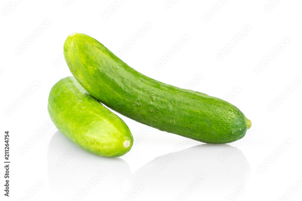 Two fresh green mini cucumbers isolated on white background. Two fresh green mini cucumbers isolated on white background.