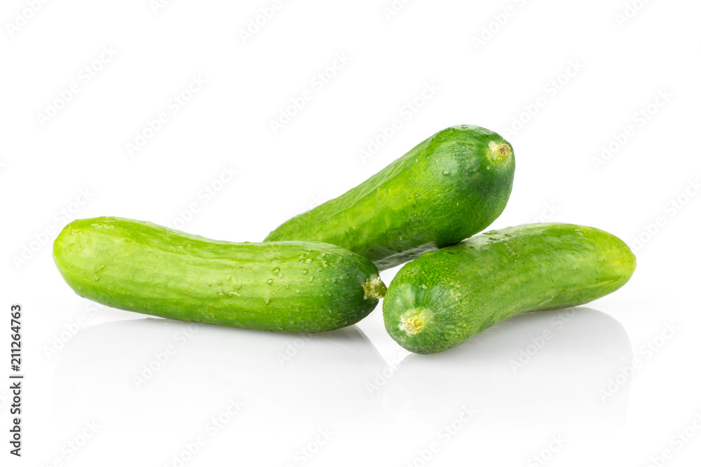 Three fresh green mini cucumbers isolated on white background. Three fresh green mini cucumbers isolated on white background.