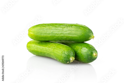 Three fresh mini cucumbers isolated on white background.