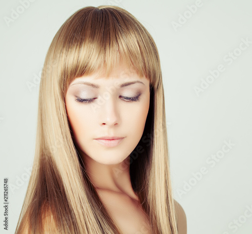 Beautiful female model woman with long blonde hair on background