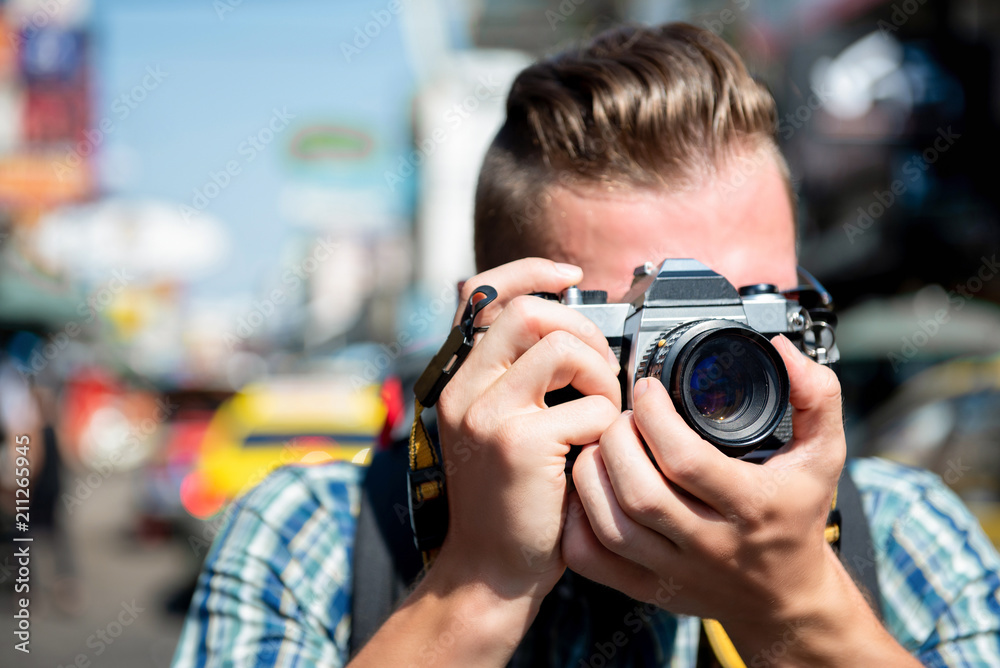 Tourist photographer taking photo in Khao san road Bangkok, Thailand Tourist photographer taking photo in Khao san road Bangkok, Thailand