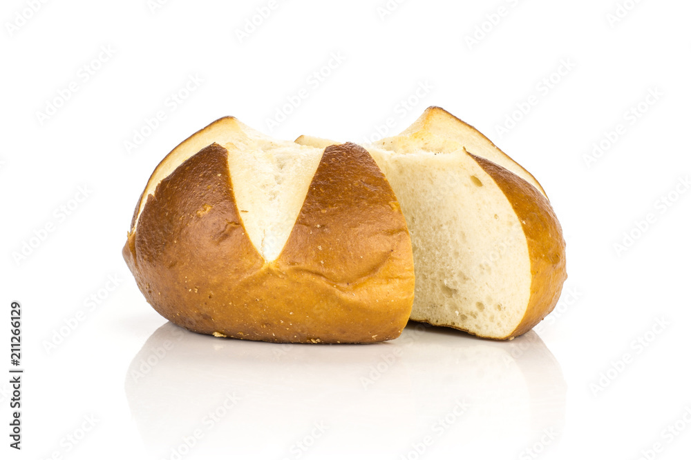 Sliced Bavarian bread bun one cut in two halves isolated on white background fresh baked loaves. Sliced Bavarian bread bun one cut in two halves isolated on white background fresh baked loaves.