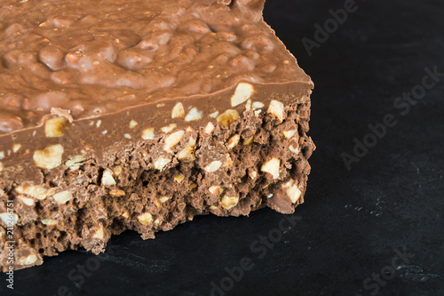 A big bar of milk chocolate with nuts and airbubbles photo