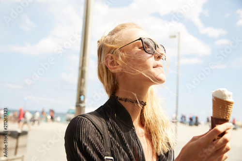 A girl enjoying ice-cream on the beach of Barcelona