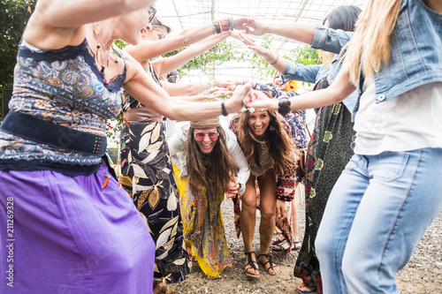Fotografie happy females with colorful and hippy clothes and dress have fun together celebrate an event with plays and dance