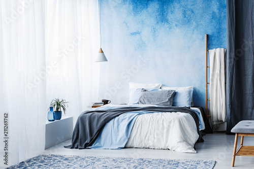 Wallpaper Mural Grey and blue bedding on bed against ombre wall in minimal bedroom interior with ladder Torontodigital.ca
