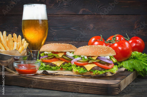 Hamburger and light beer on a pub background.