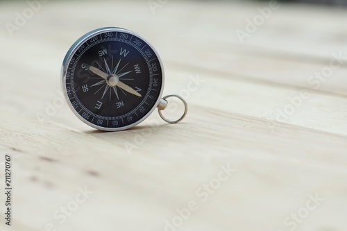 Compass on wooden table, copy space, journey concept