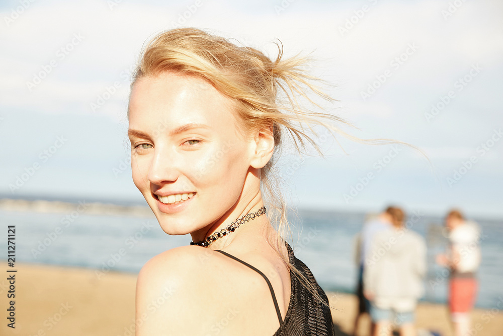 Portrait of a beautiful model girl on the beach with hair winding Portrait of a beautiful model girl on the beach with hair winding