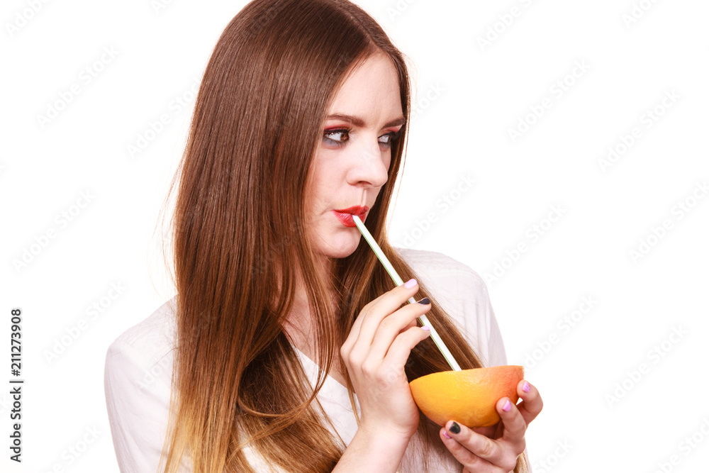 Woman holds grapefruit drinking juice from fruit Woman holds grapefruit drinking juice from fruit