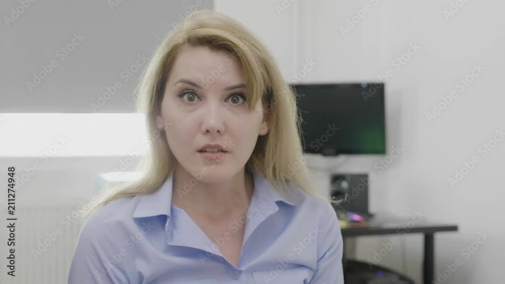 Corporate young woman with scared and terrified expression on face big eyes and opened mouth being shocked by unexpected negative information Corporate young woman with scared and terrified expression on face big eyes and opened mouth being shocked by unexpected negative information