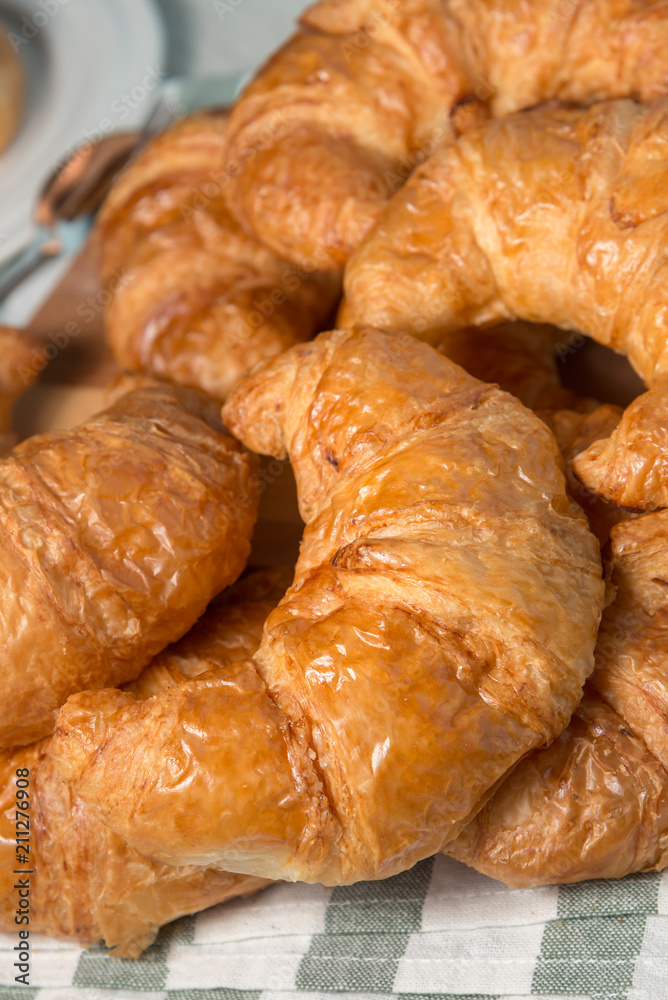 breakfast bakery concept : fresh french croissant on wooden background