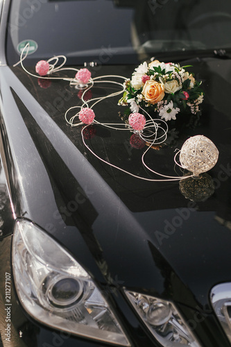 black car with stylish wedding bouquet. wedding transportation decor, adorning and arrangement