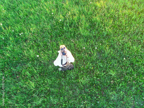 photographer on a green field photo from a height
