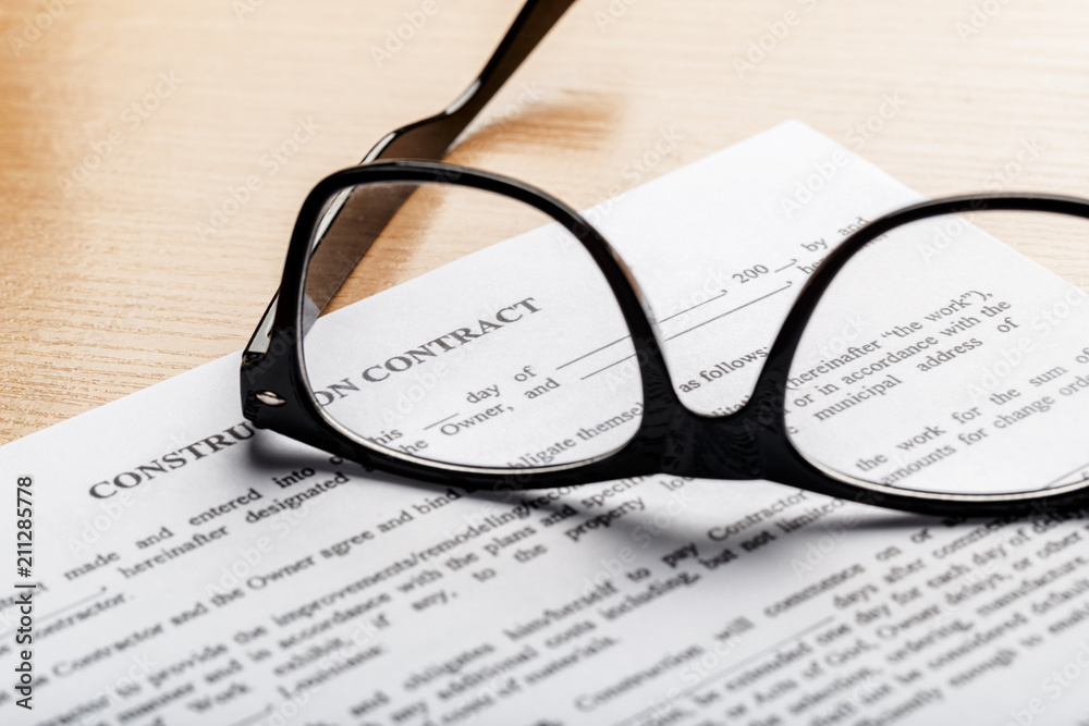 Close up shot of Eyeglasses on document papers business concept Close up shot of Eyeglasses on document papers business concept