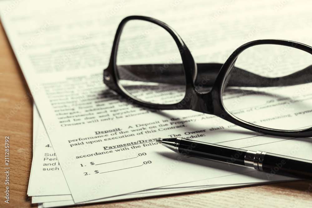 Close up shot of Eyeglasses on document papers business concept Close up shot of Eyeglasses on document papers business concept