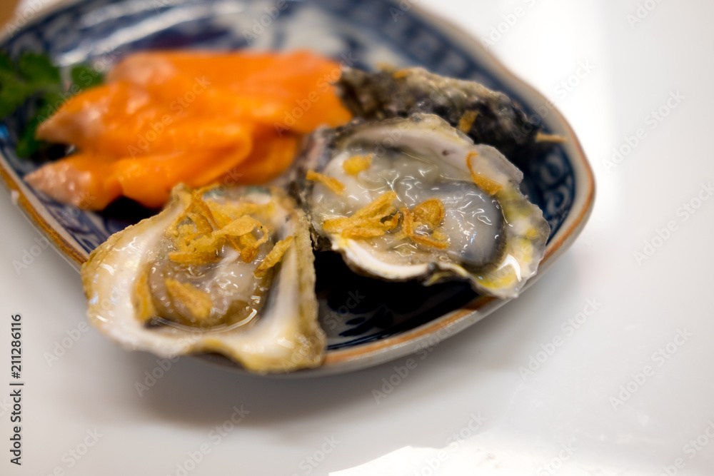 Tasty fresh oysters on plate.