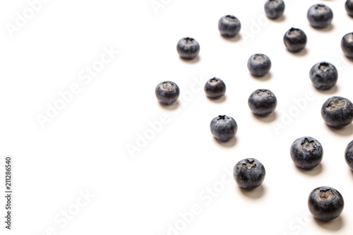Bunch of fresh organic blueberry berries in seamless pattern on white background. Clean eating concept. Healthy nutritious vegan snack, raw diet. Close up, copy space, top view, flat lay.