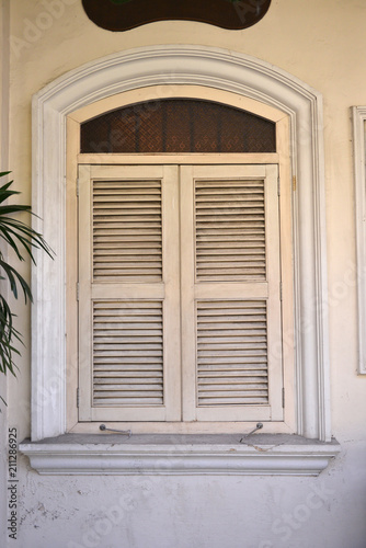 a row of old vintage windows on a street in the city.