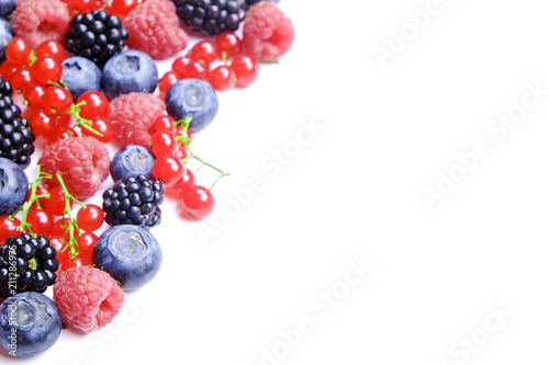 Bunch of mixed berries in harvest pile on white background. Colorful composition with fresh organic strawberry  blueberry  blackberry   redcurrant. Clean eating concept. Close up  copy space  top view