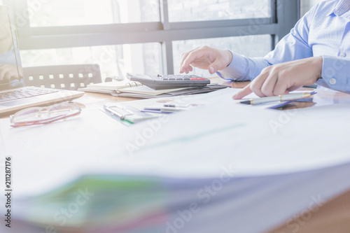Administrator business man financial inspector and secretary making report, calculating or checking balance.