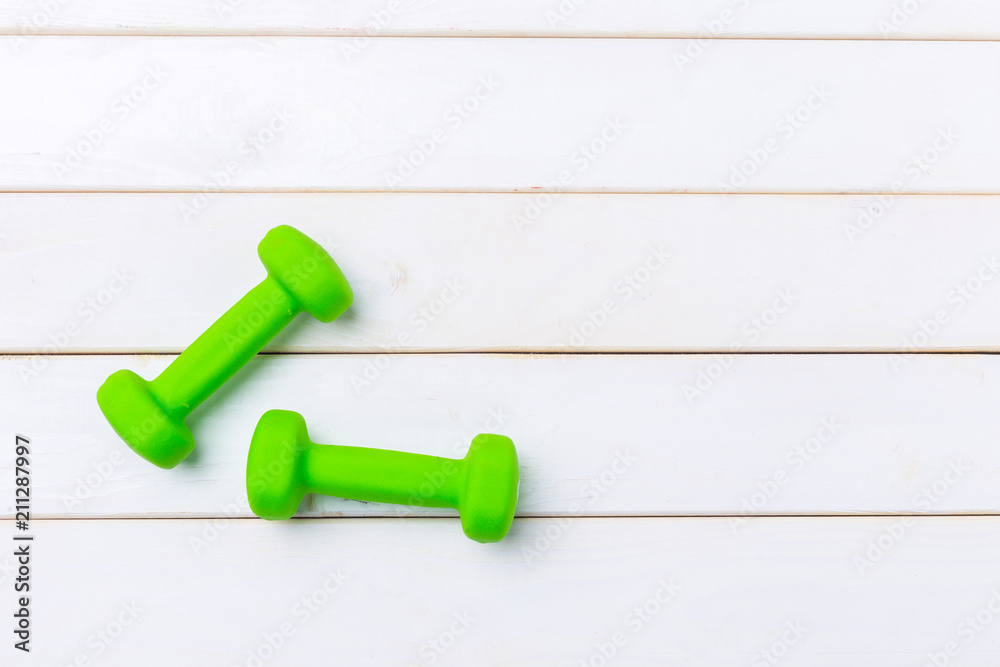 dumbells on wooden floor dumbells on wooden floor
