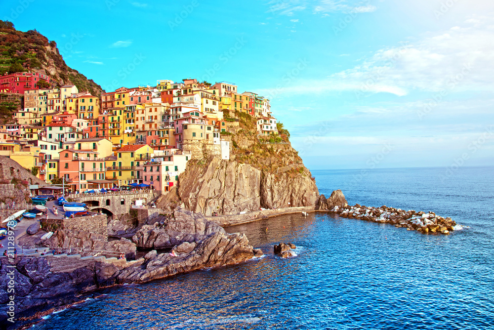 Charming beautiful landscape with bright colored houses on the rock on the seafront of Manarola in Cinque Terre, Liguria, Italy, Europe in sunlight