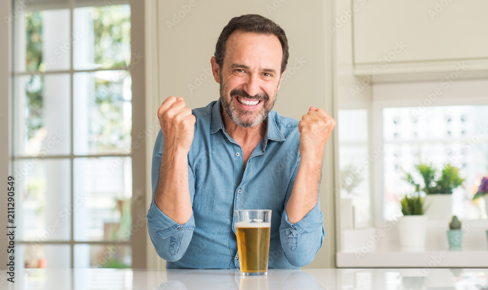 Middle age man drinking beer screaming proud and celebrating victory and success very excited, cheering emotion Middle age man drinking beer screaming proud and celebrating victory and success very excited, cheering emotion
