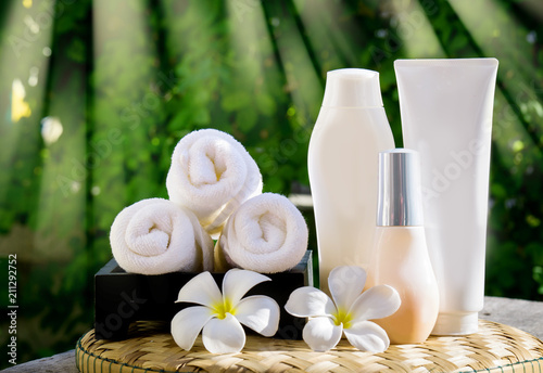 Body care product,shampoo,conditioner,haircoat  with plumeria flower on nature background photo