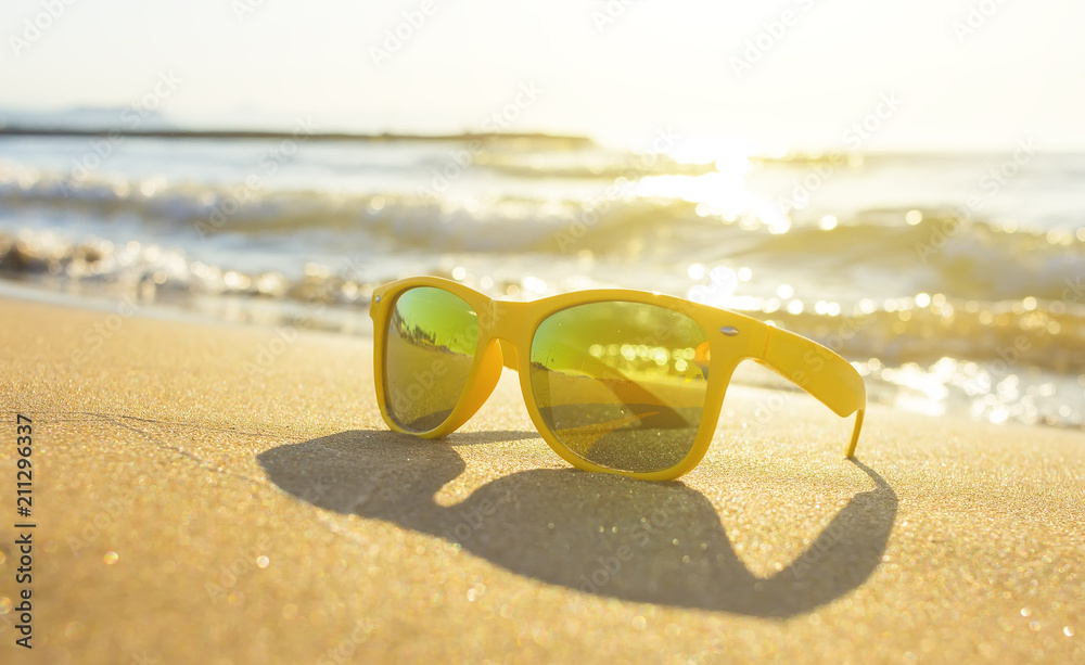 Fashion sunglasses on sea beach with clear blue sky. Summer holiday relax  background Stock Photo