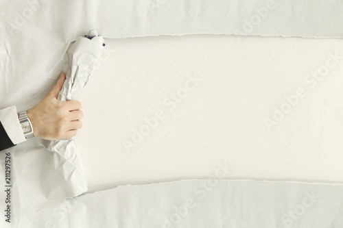 Photography ripping a paper sheet