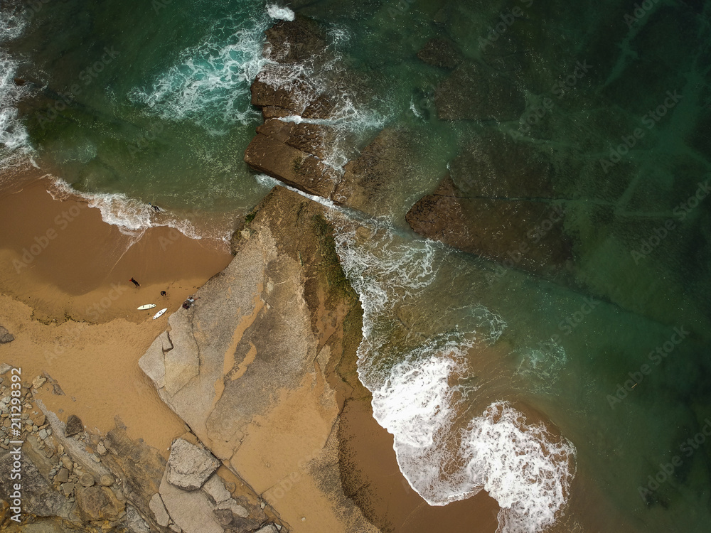 surfer on the beach top view. Drone shot on a beach in a summer day.