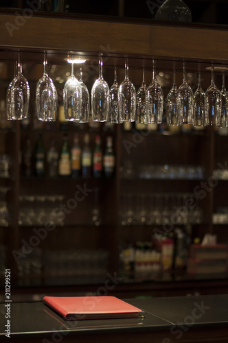 Group of champagne glasses over the bar in pub and restaurant. Soft focus