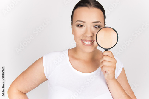 beautiful girl with perfect skin commercial face type holding magnifier beauty skin concept © oreans