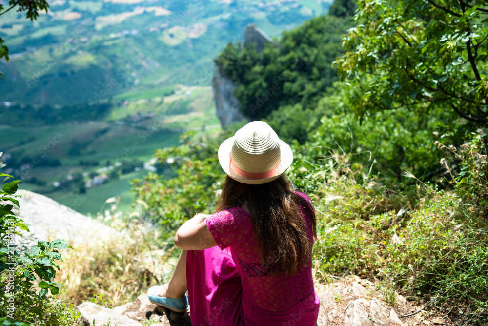 A beautiful touristic girl in the San Marino, admiring the view
