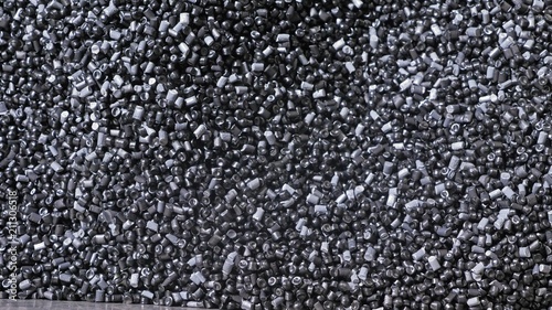 Plastic black gray granulated crumb. Manufacture of plastic water pipes of the factory. Process of making plastic tubes on the machine tool with the use of water and air pressure.