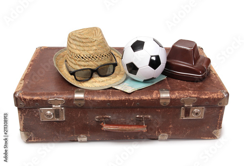 Old suitcase and soccer ball on white background photo