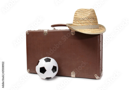 Old suitcase and soccer ball on white background photo