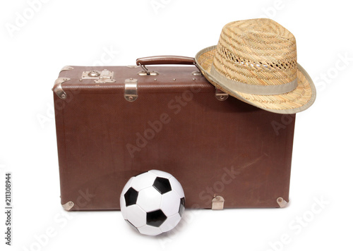 Old suitcase and soccer ball on white background photo