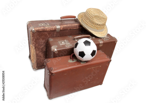 Old suitcase and soccer ball on white background photo