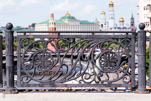 Black cast iron fence of the bridge over the Moscow river in the city center with a view of the Kremlin