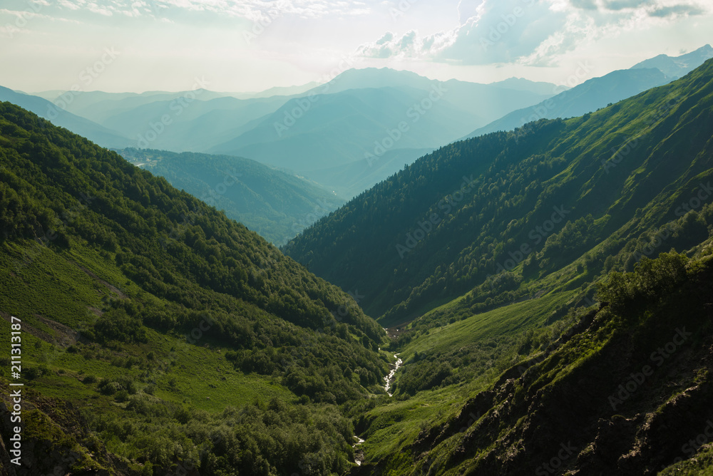 The Grand Canyon of the Bzerpi River. High mountain peaks and blue sky. Mountain tourism. The Grand Canyon of the Bzerpi River. High mountain peaks and blue sky. Mountain tourism.