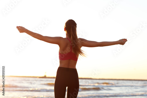 Woman running alone at beautiful dusk on the beach © Kalim