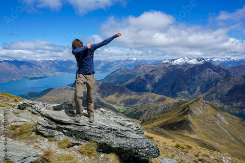 Man dabbing on the top of Ben Lomond in Queenstown New Zealand